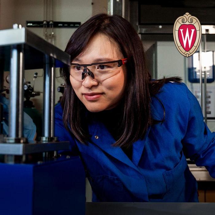 Young female student in the lab. UW Madison 标志 in the top left corner